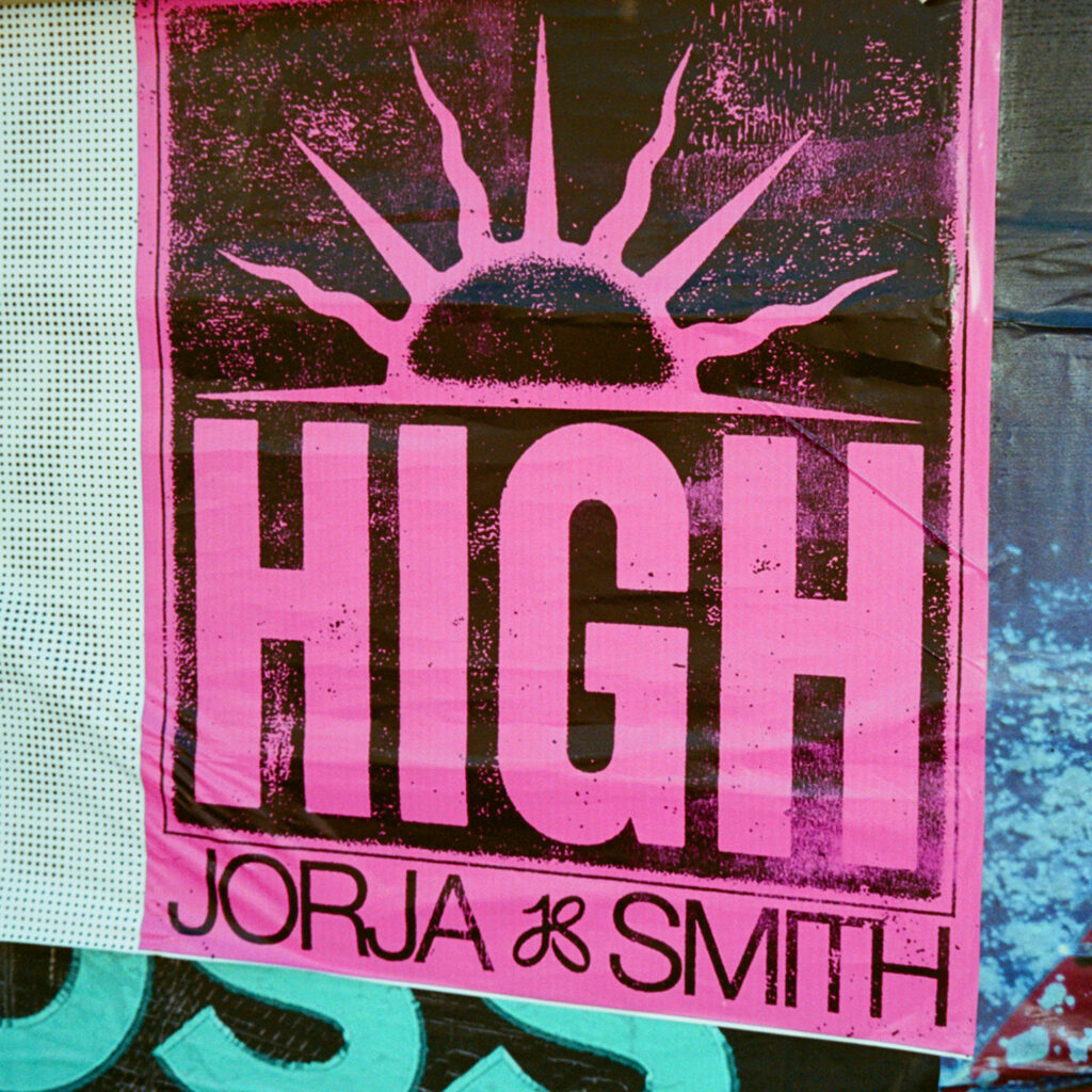 Bright poster with a stylized sun graphic at the top and the word "HIGH" in bold letters. Below, "JORJA & SMITH" is printed in smaller type. The background is a textured pink and blue.